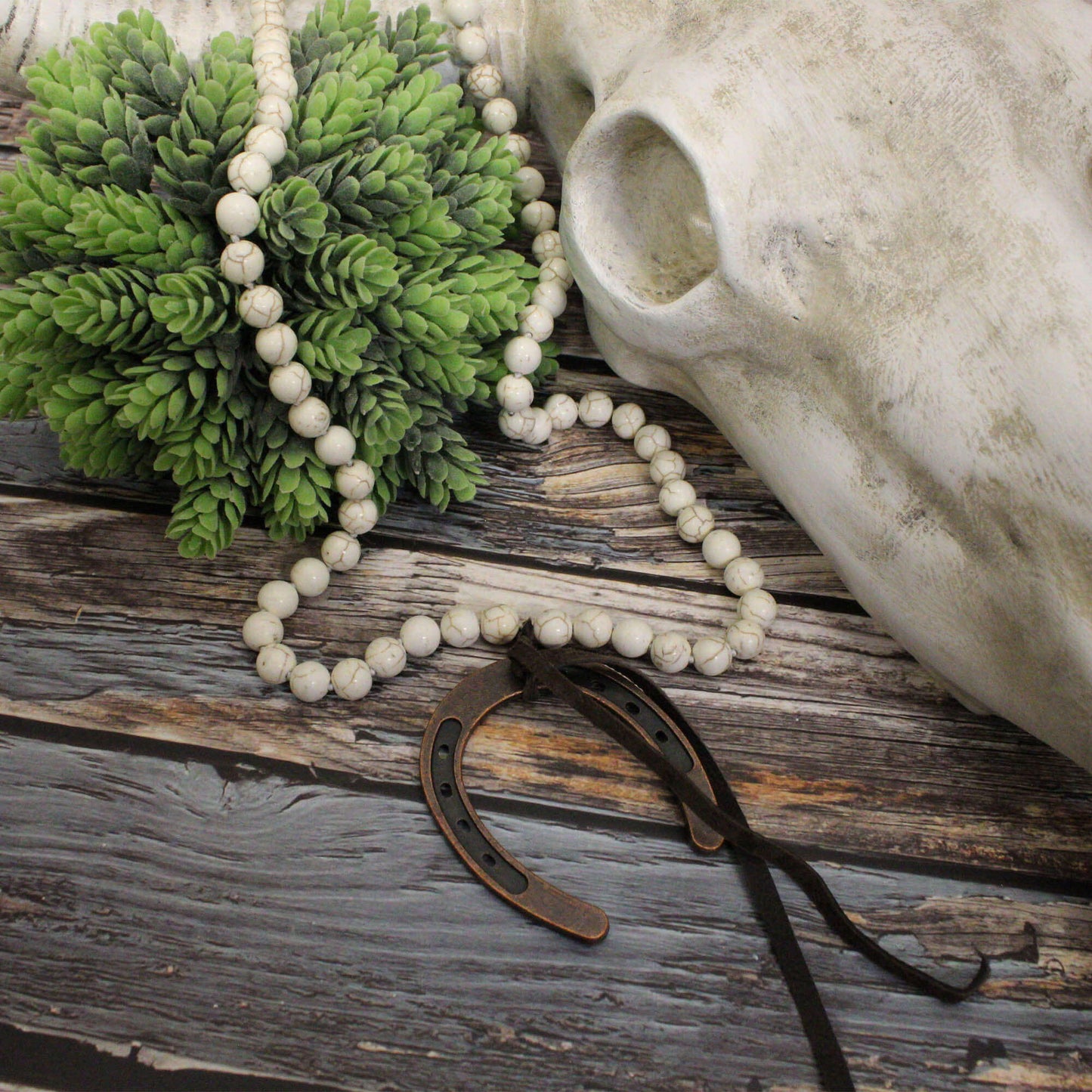 Handcrafted in the USA, this bohemian-style piece measures 46 inches in length, allowing for versatile styling options—layer it for a bold statement or wrap it around your head for a unique twist. The large horseshoe pendant, measuring 2.75" x 2.25", is complemented by a chic brown tassel. Embrace your free spirit and showcase your individuality with this eye-catching necklace that effortlessly blends rustic charm with modern flair.
