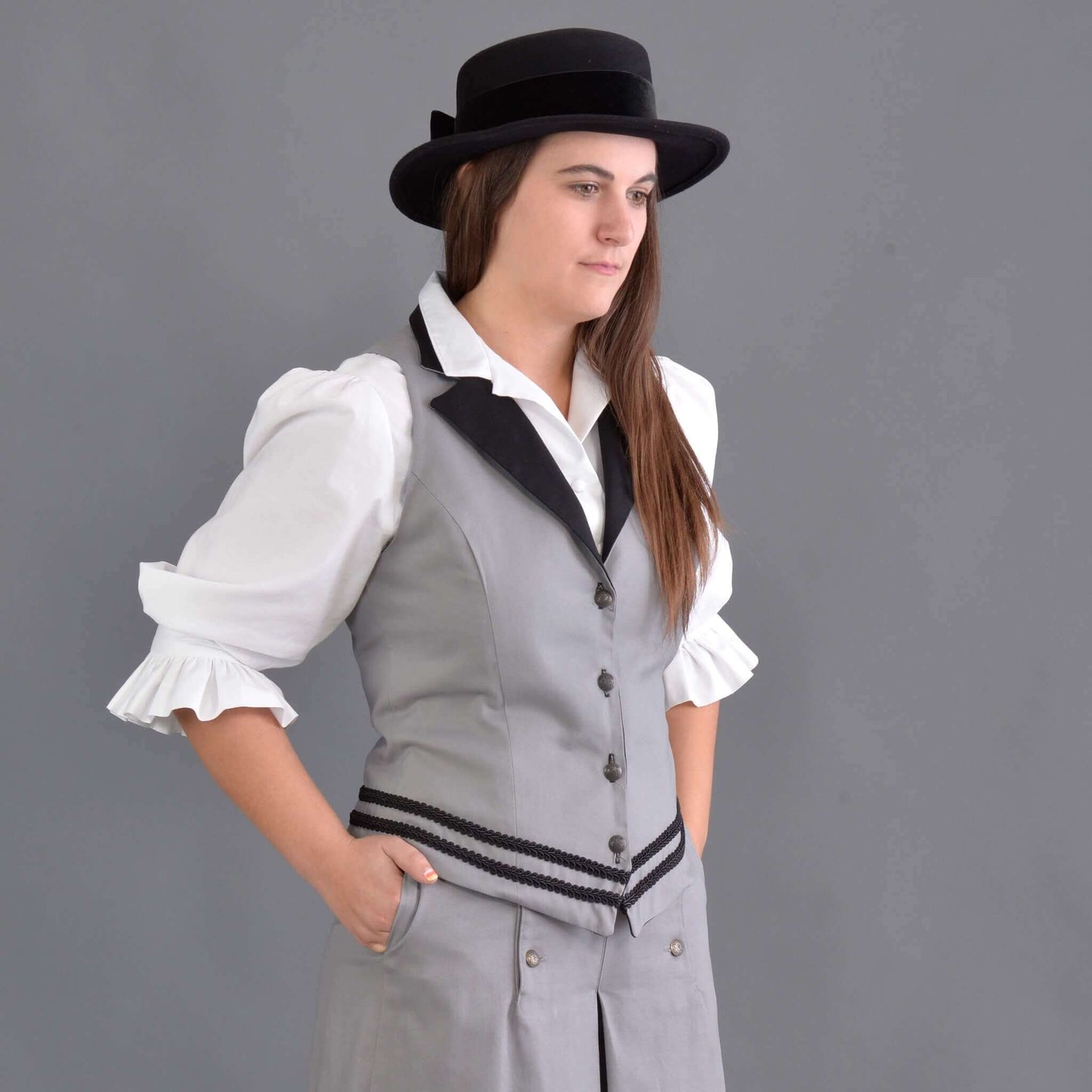 Our summer version to our riding jacket is this new Riding Vest. Stay cool in the summer heat or wear it with a blouse to stay warm and look great either way! Available in six great colors with black contrasting lapels and two rows of rayon black braid along the bottom. Silver engraved Victorian style buttons accent this vest and match our 1800’s riding skirt. Wear it with our matching riding skirts or with your favorite pair of jeans. Made of 100% cotton twill and lined in polyester.