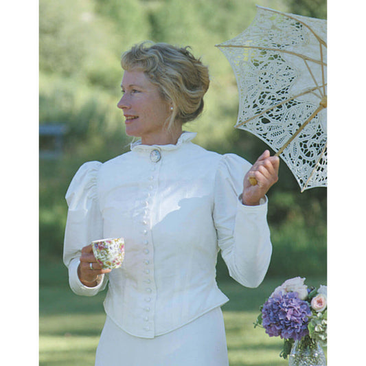 Woman wearing a Victorian Western Silk Walking Jacket, holding a teacup and a lace parasol in a garden setting.