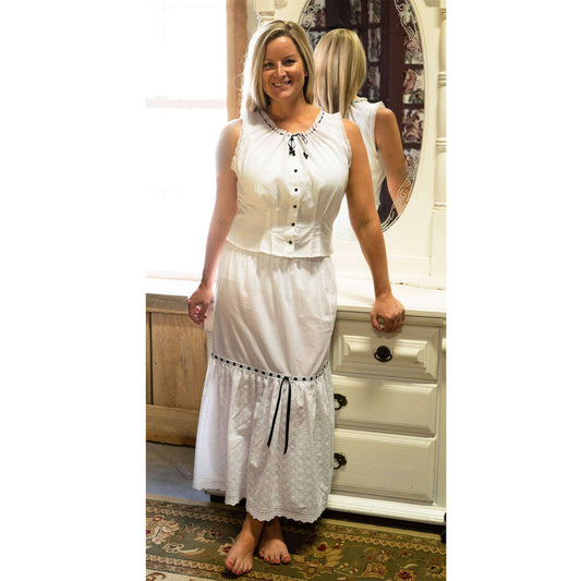 A great addition to the Scottsdale dress, this white cotton eyelet petticoat can be worn under any skirt or dress. Measures 33" long. Elastic Waistband with black ribbon trim. This camisole, which also makes a lovely summer top, is trimmed in  black lace, ribbons and rosettes.