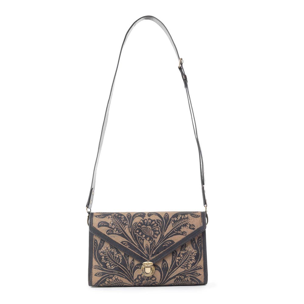 Floral patterned handbag with a strap on a white background