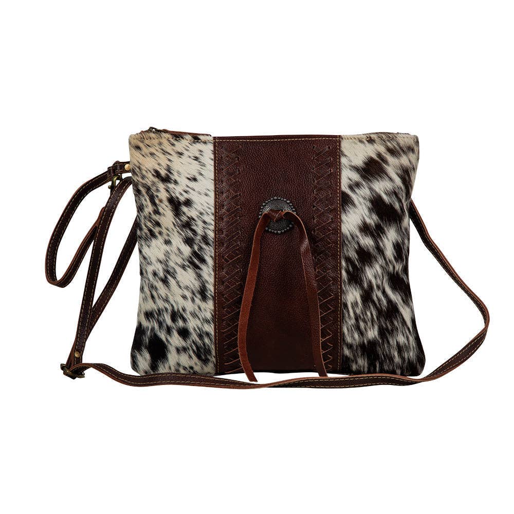Crossbody bag with cowhide leather pattern on a white background