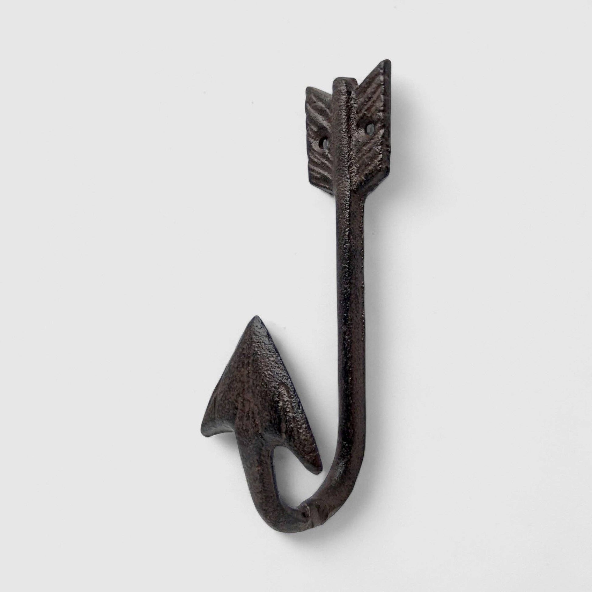 Decorative metal hook with arrow design on a light gray background