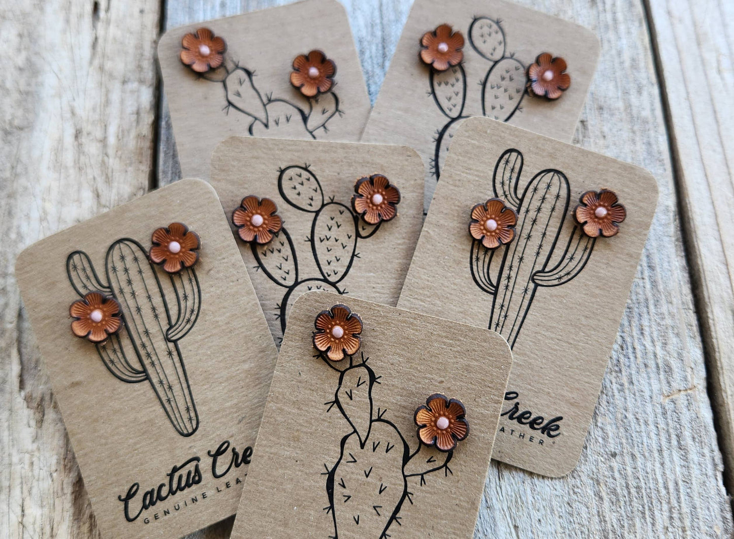 Cactus-themed earrings on kraft paper cards with 'Cactus Creek' branding.