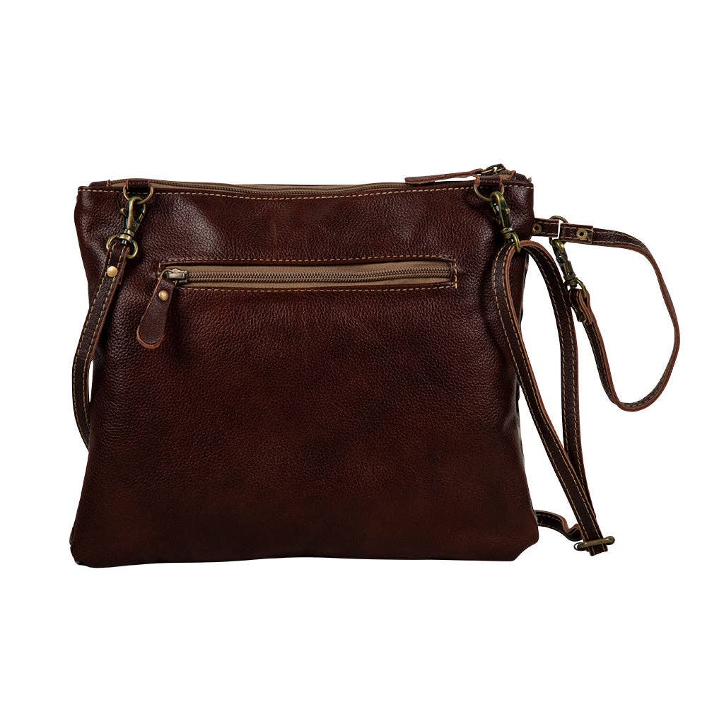 Brown leather crossbody bag on a white background