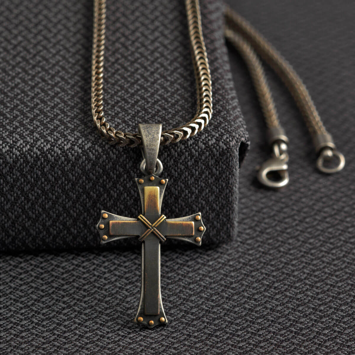 This chain necklace has a very edgy look. &nbsp;The 22" chain is a small rope style with a 3 dimensional gold/silver cross about 2" long by 1-1/4" wide. &nbsp;Made of Silver Plated Zinc (Nickle, Lead and Cadmium free). Designed in USA. Made in Taiwan.