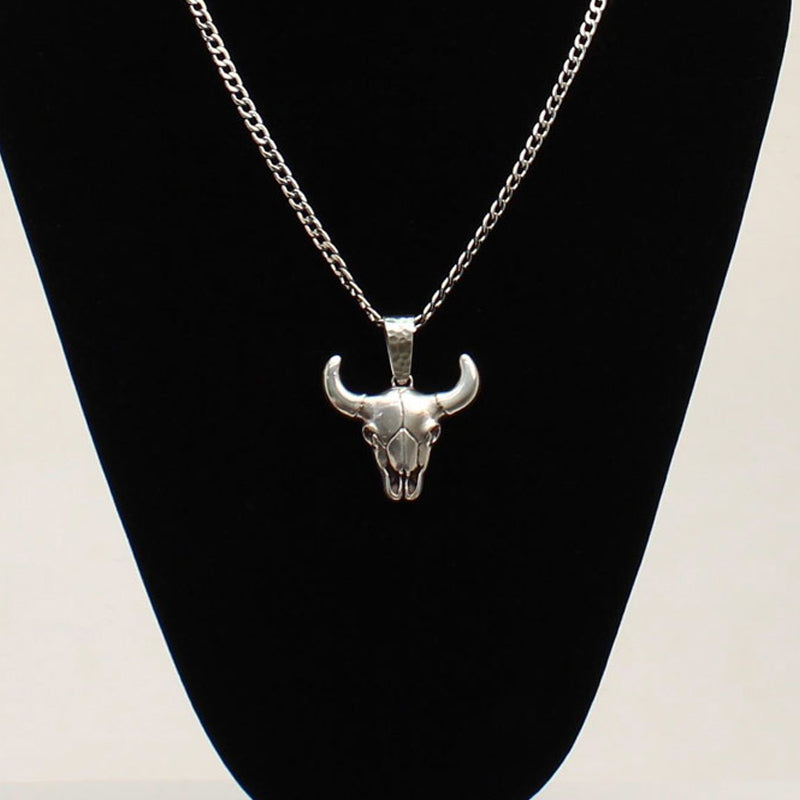 This beautiful Twister skull head necklace is a head turner. The detailed pendant is silver tone and rests on a 22” stainless steel chain. Imported.