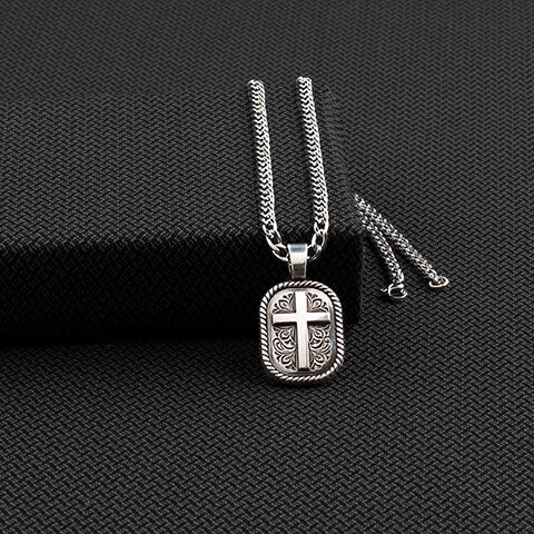 A beautiful pendant with a cross motif accented with a floral engraved design, that hangs from a 22 inch stainless chain. Pendant measures 1.25" by 1". Imported