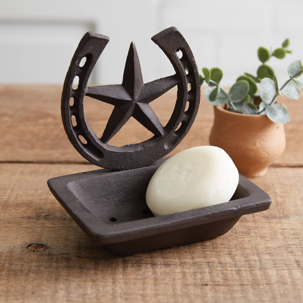 Wash up from a long day of riding horses with this western soap dish. Display in your bathroom or kitchen to accent any western cabin or country home. A star and horseshoe adorns the top of the dish. Item is made of cast iron and features drain holes for ease of cleaning.