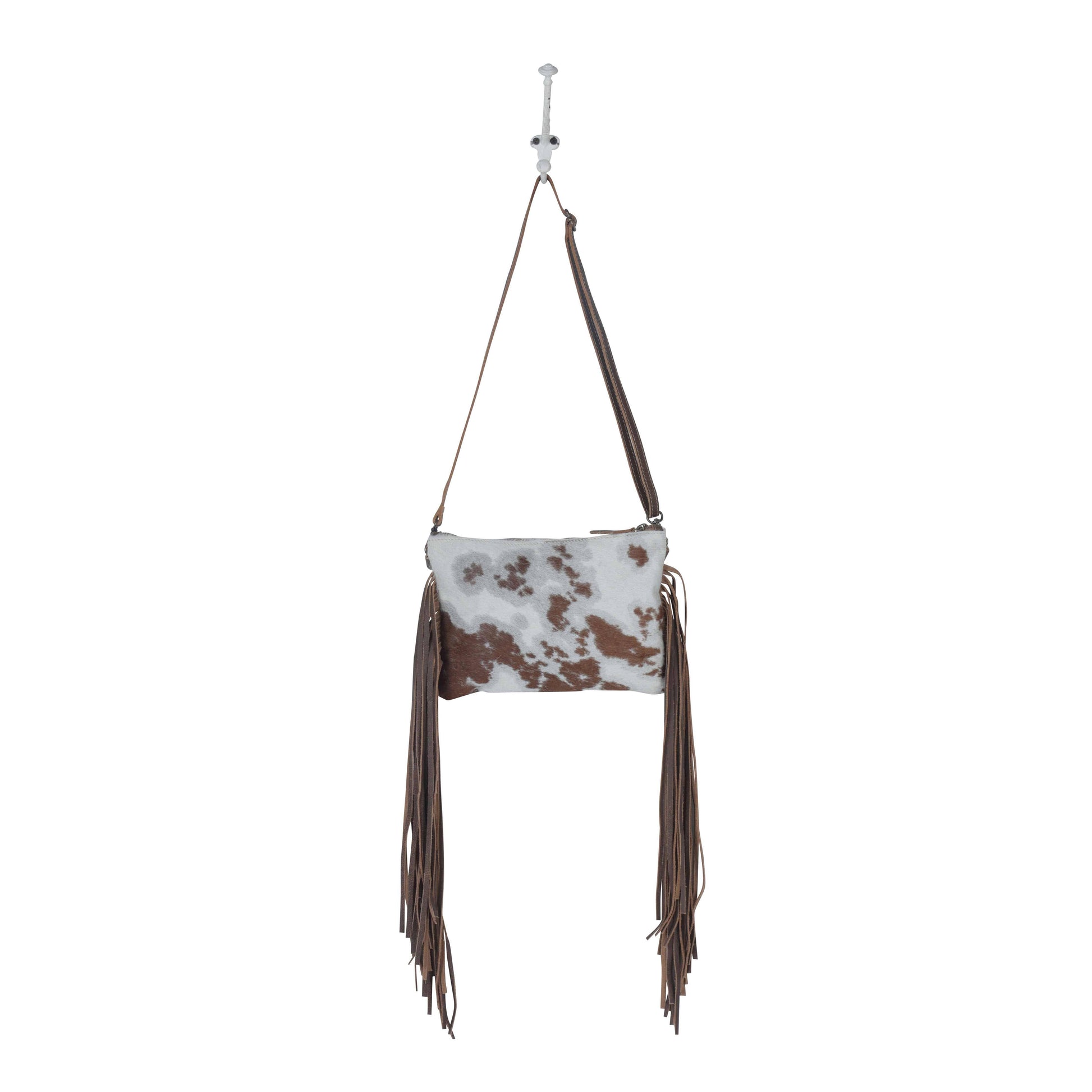 Cowhide leather handbag with fringes on a white background