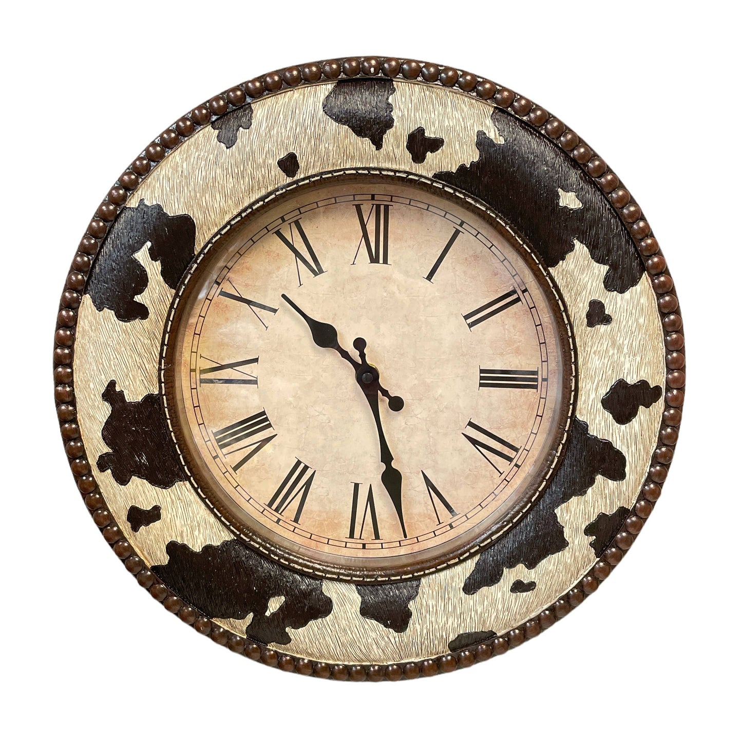 Decorative wall clock with cow print design on a white background
