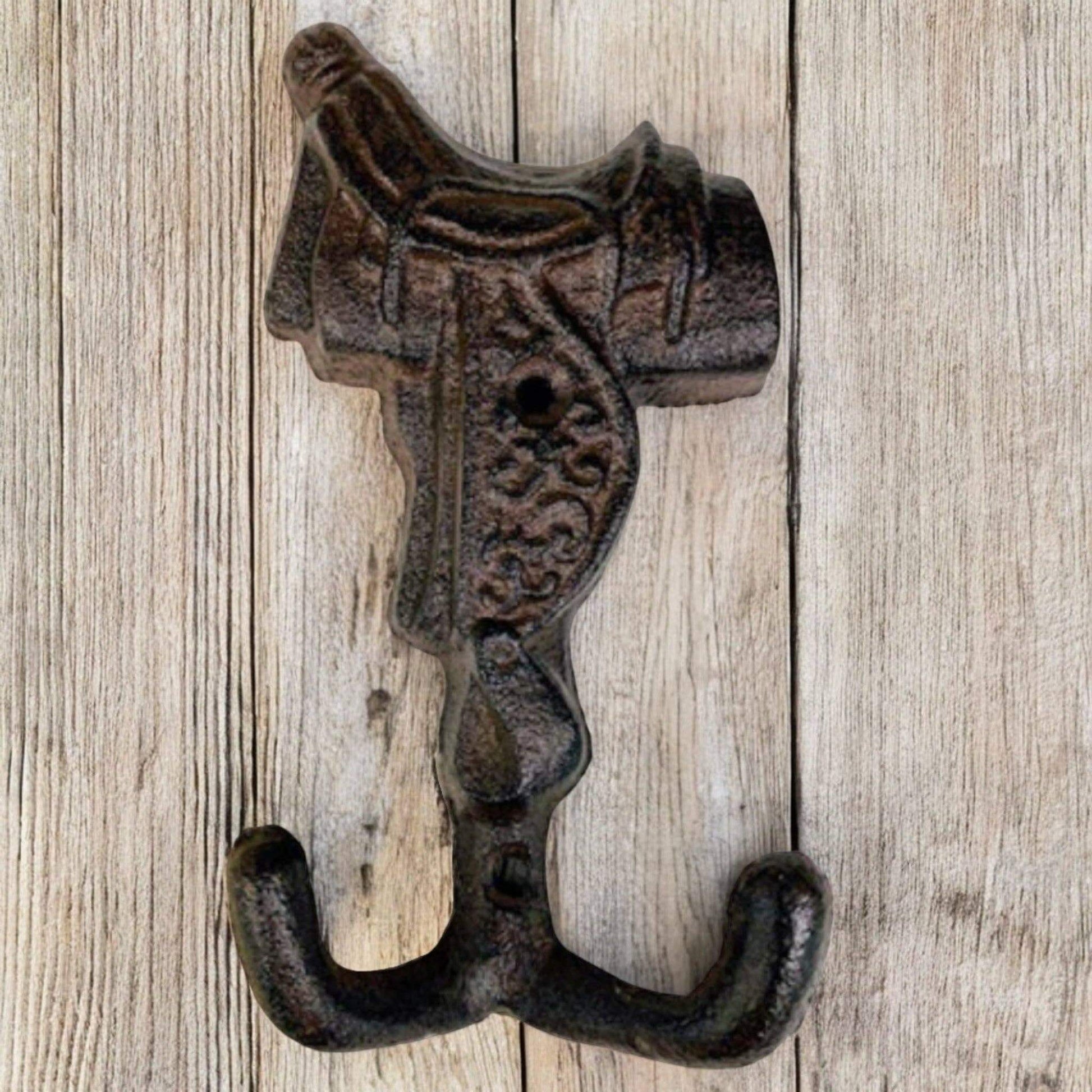 Old West Cast Iron Horse Saddle Hook designed for coats, scarves, or horse tack, featuring a rustic finish.