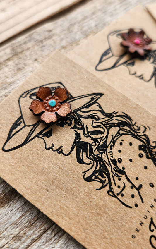 Decorative Leather Hat Pin floral design on a wooden surface