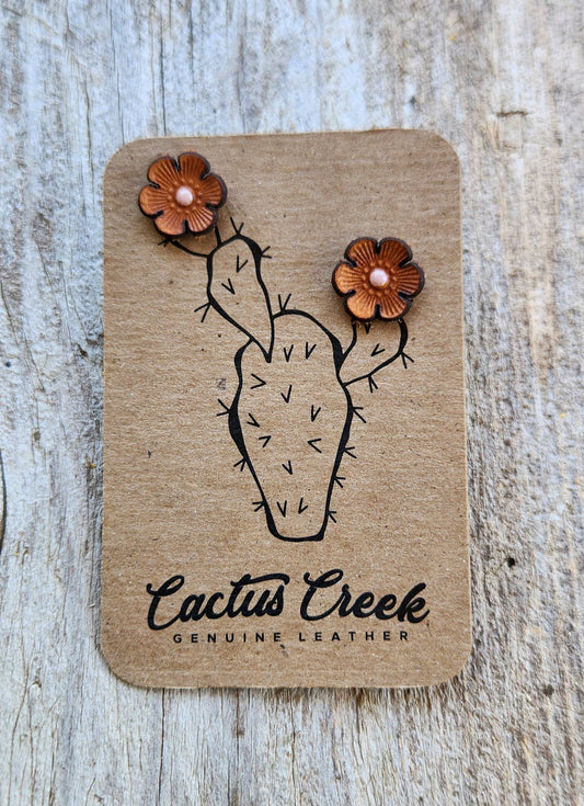 Pair of leather earrings shaped like cacti on a Cactus Creek branded card.