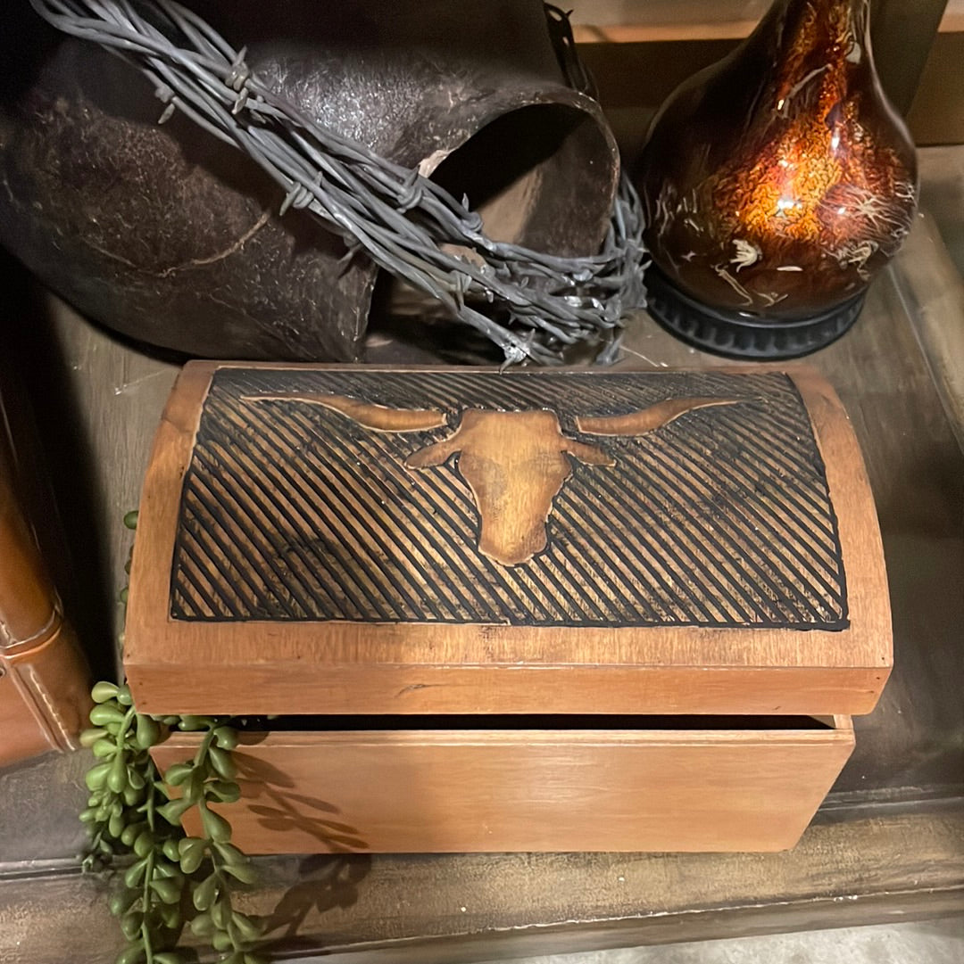 Bring the spirit of the old west right into your home with the Longhorn Box. The wooden construction and etched longhorn design give this storage box plenty of rustic flair. Use it to neatly store household items while adding a decorative focal point. The rounded hinged top makes it easy to access the contents.