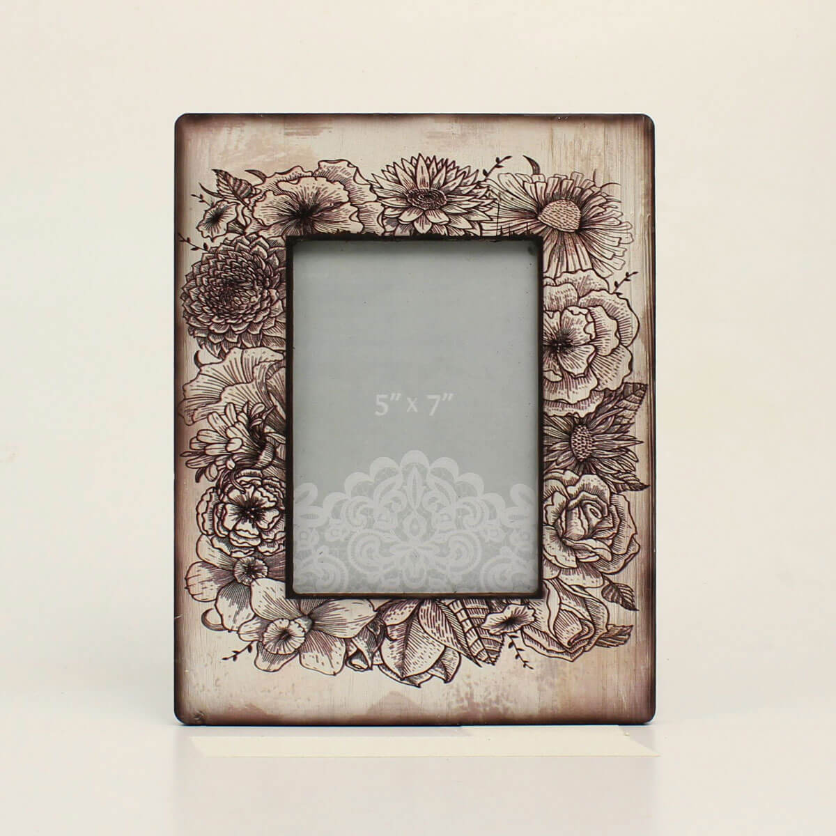 Beautifully display your favorite memories in this photo frame with sketched flowers around the frame that add a classic rustic charm with a modern flair. This frame will look great on your coffee table, or office, or proudly give as a gift. Holds 5 x 7 Picture.&nbsp;Dimensions: 11-1/2 x 9