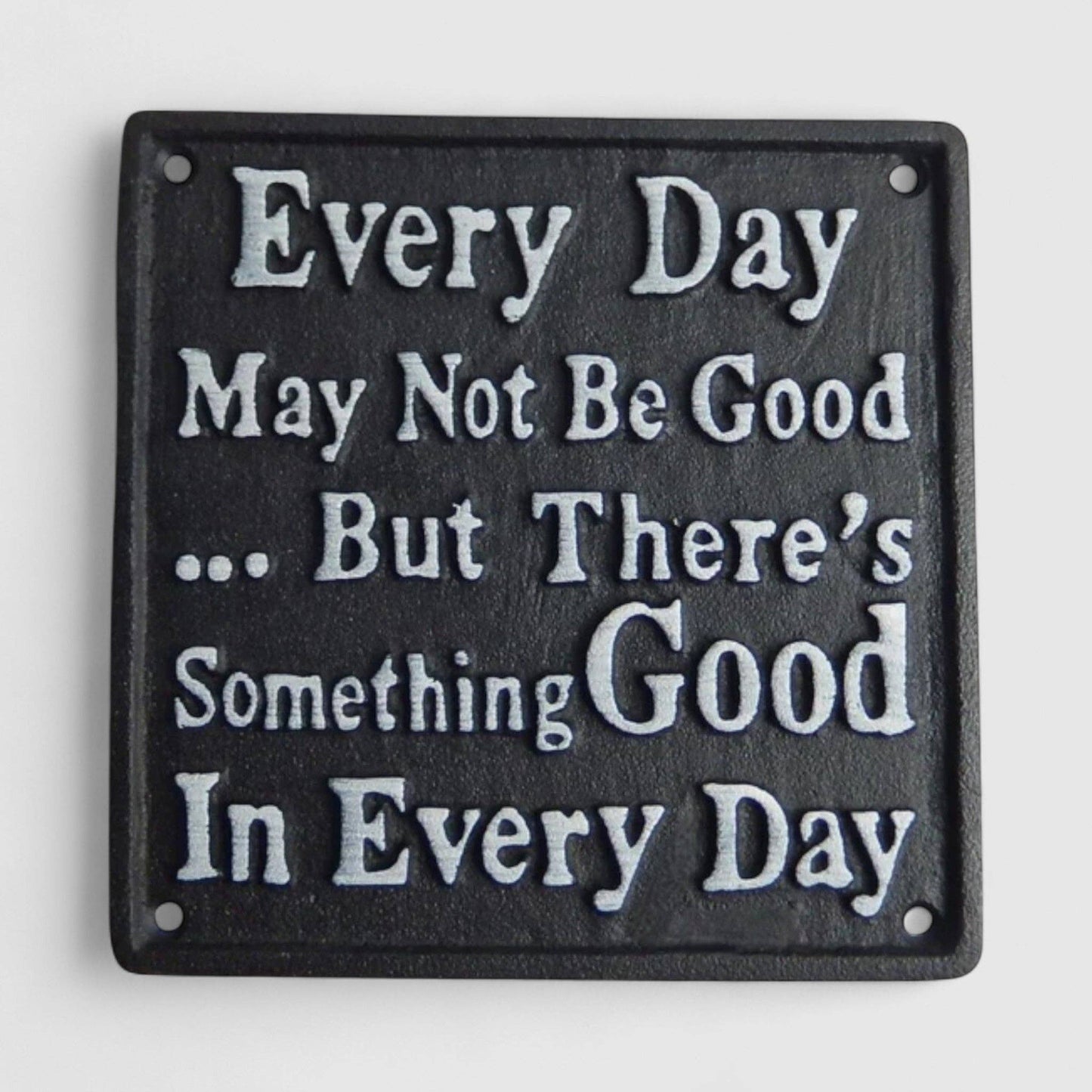 Decorative plaque with motivational quote on a white background