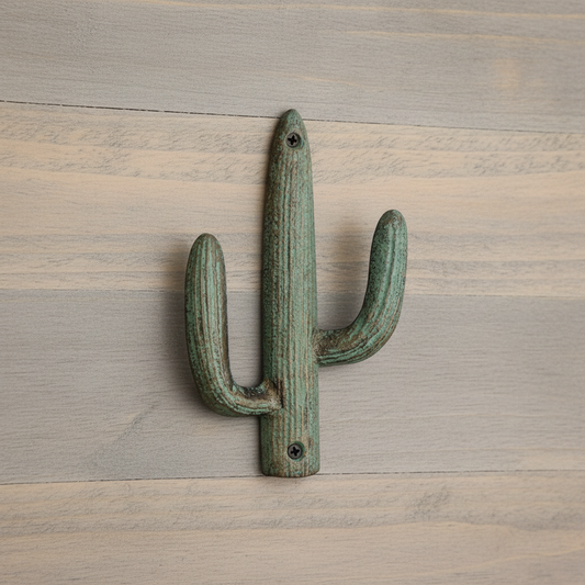 Cactus-shaped wall hook on a wooden surface