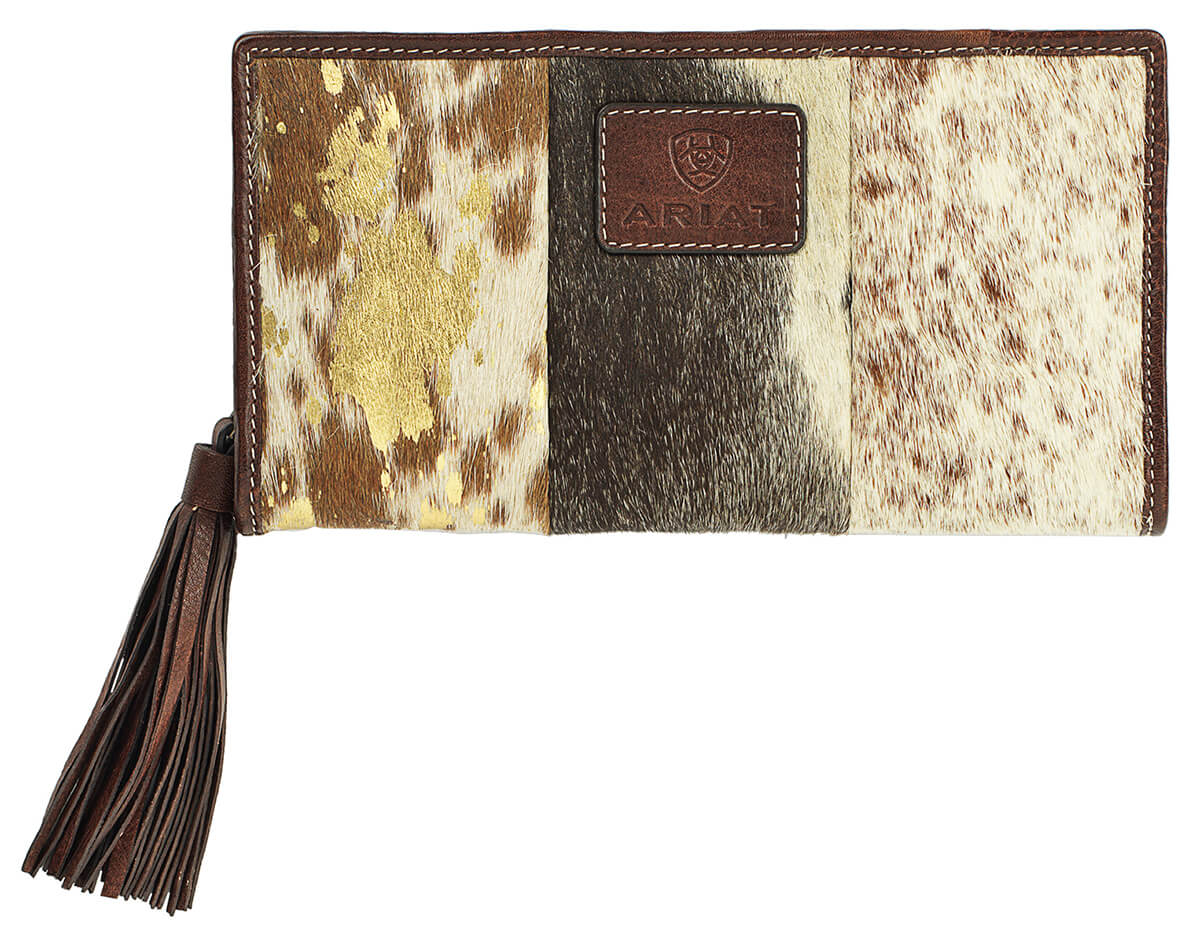 Meet the Savannah clutch wallet. This exclusive design features genuine leather, patchwork calf hair, and a zip closure accented with suede fringe tassel.