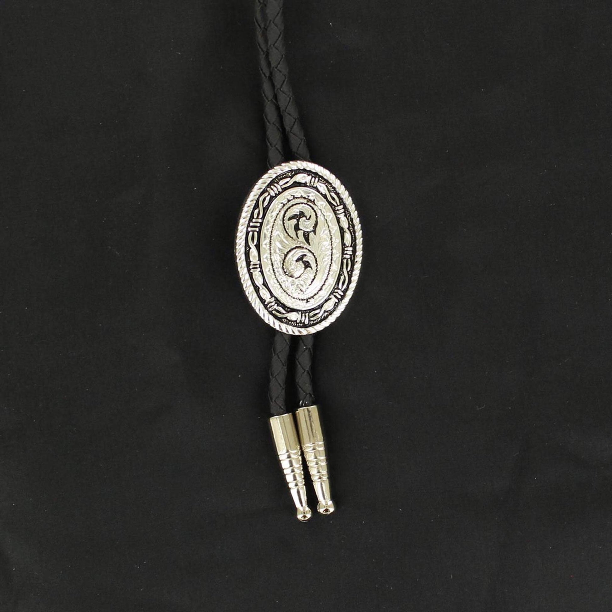 Add some flair to your western wear! This western bolo tie features a black braided rope with silver tips accented with a silver oval Concho with rope edge, barbwire, and western scroll inside on a black background. Adult bolo-36" long. Imported