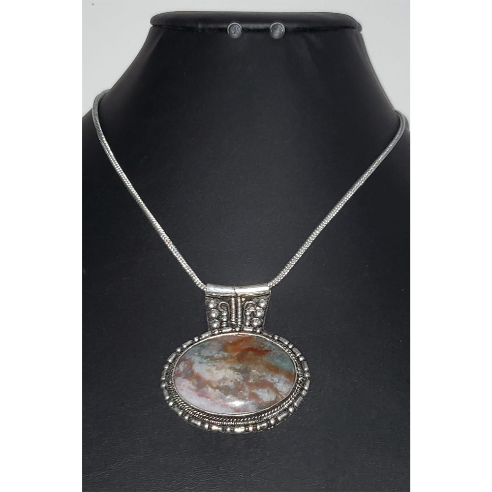 Agate oval pendant with a silver tone frame on a snake link chain. Necklace measures 21″ with a lobster claw clasp and extension.&nbsp;