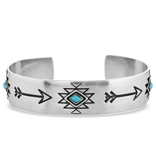 <span data-mce-fragment="1">Silver-toned, adjustable cuff with arrows and geometrics designs. Turquoise stones are placed throughout. Measures 1/2" wide. Fits most. Made of a</span><span data-mce-fragment="1">ntique silver over a brass base. Turquoise stone.</span>