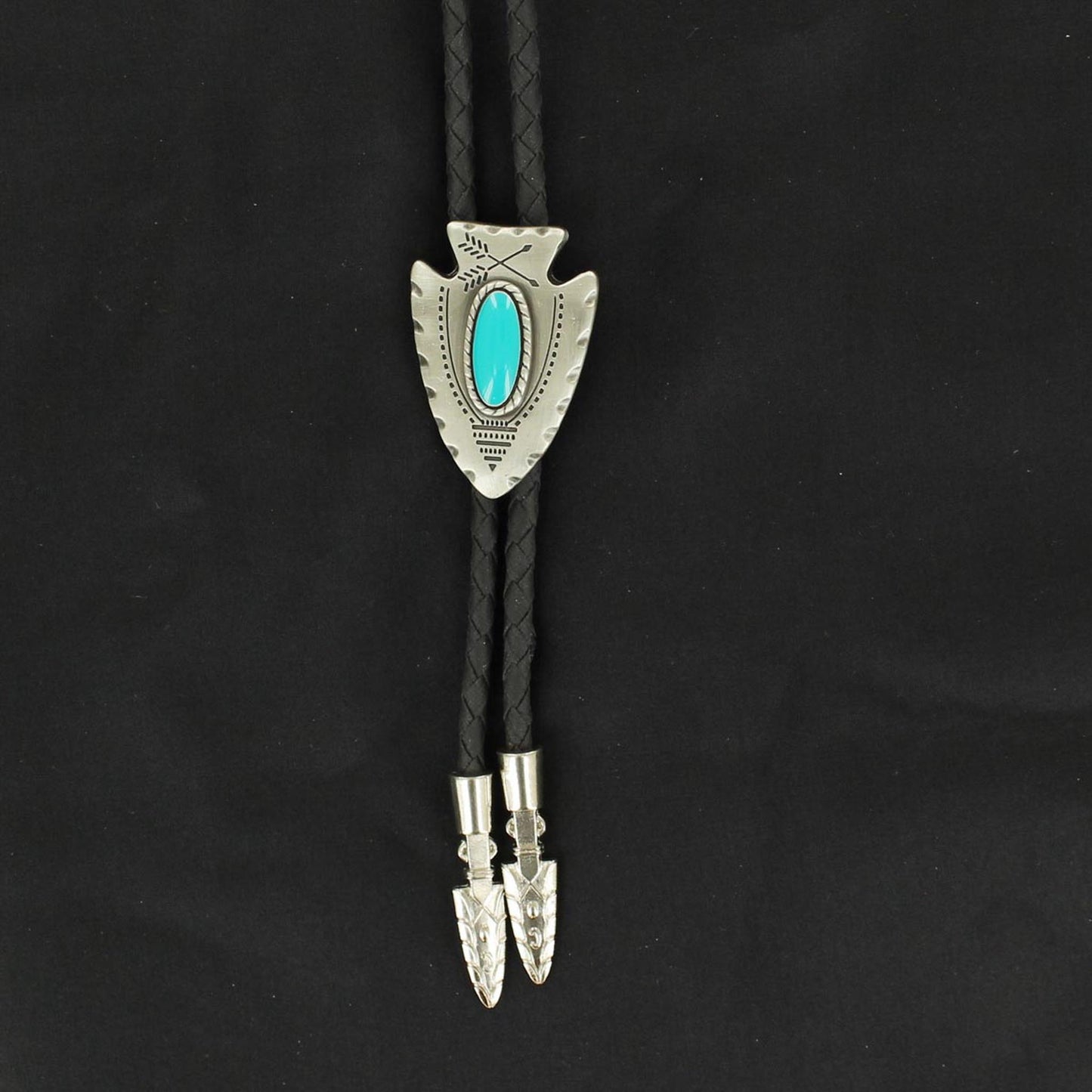 Classic black leatherette bolo cord with silver arrow tips. Antiqued silver Indian inspired arrowhead bolo with turquoise in the center. 36 inches long.