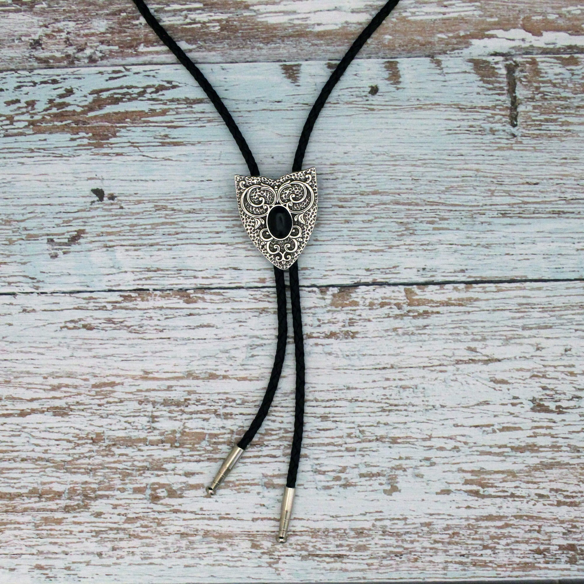 Decorative bolo tie on a wooden surface