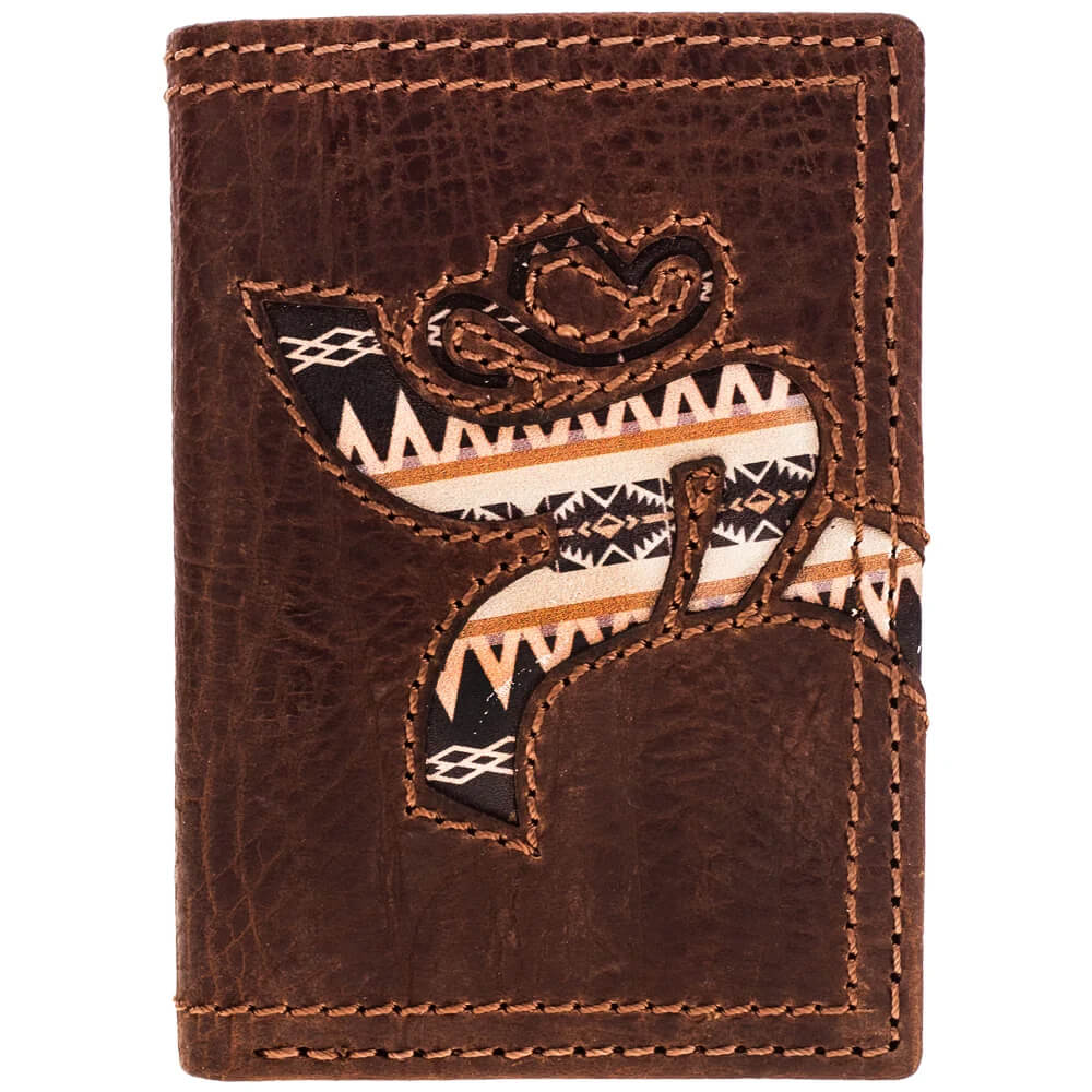 A brown leather bi-fold wallet featuring a western-style embroidered design of a cowboy silhouette wearing a hat, with geometric Southwestern patterns in black, white, and orange.