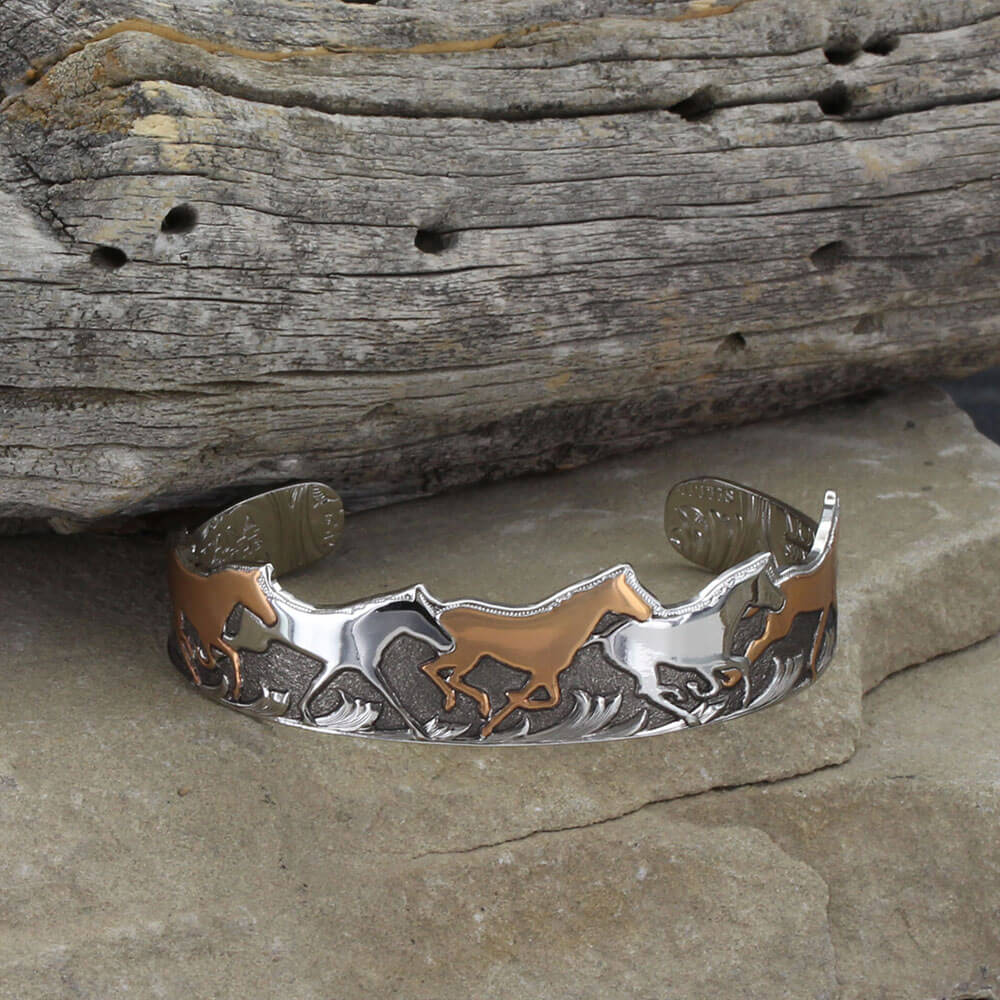 A beautifully vintage cuff bracelet with silver and umber tones on a string of running horses with at deep black hand painted background. One size fits most. 3/4" Wide