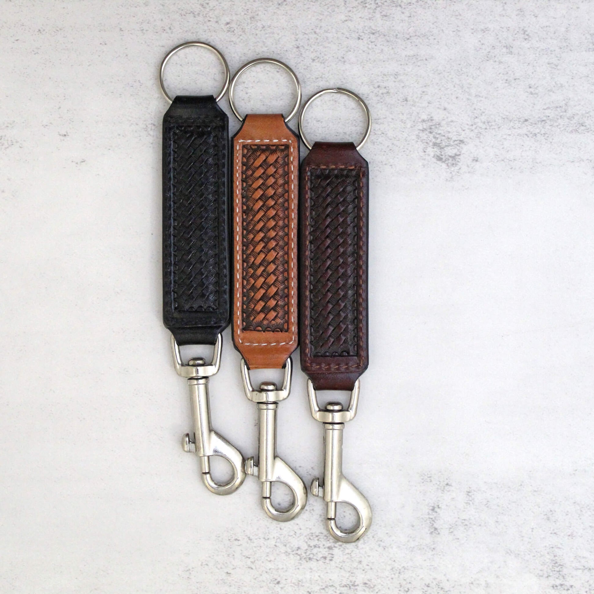 Key belt holder is constructed with high quality materials and is highly durable and well made. Basket weave stamped leather keychain helps keep your keys secure and handy with the snap clip you can clip to your belt loop or bag. Makes a great gift or stylish accessory for yourself. Measure 7" long.