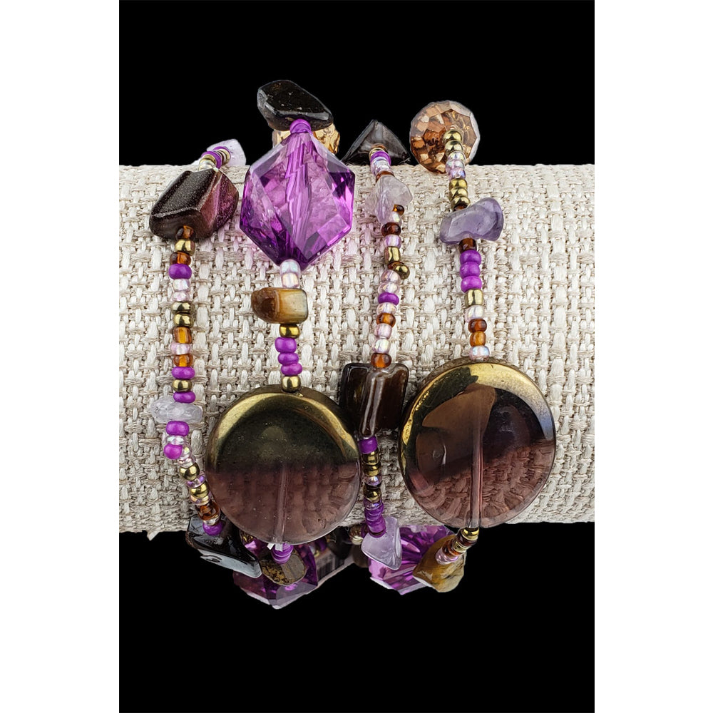 Strands of purple, bronze, topaz and plum colored beads. Adorned by Amethyst chips, and shell. One size fits most.