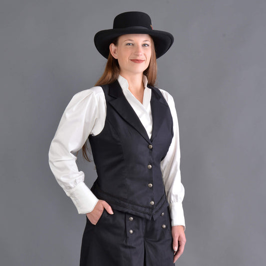 Our summer version to our riding jacket is this new Riding Vest. Stay cool in the summer heat or wear it with a blouse to stay warm and look great either way! Available in six great colors with black contrasting lapels and two rows of rayon black braid along the bottom. Silver engraved Victorian style buttons accent this vest and match our 1800’s riding skirt. Wear it with our matching riding skirts or with your favorite pair of jeans. Made of 100% cotton twill and lined in polyester.