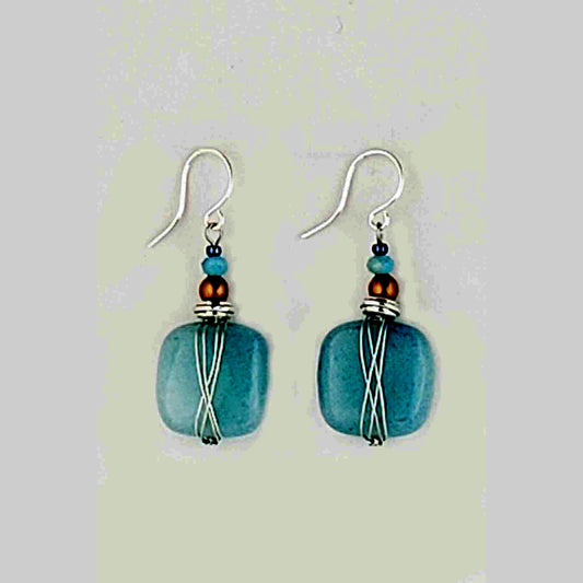 Harness the power of blue quartz to stimulate your imagination and free your mind. These earrings are the perfect accessory for artists, writers, and anyone seeking a boost of creative inspiration. Wear them daily to tap into your inner wellspring of ideas and bring your visions to life. Measures approx. .5" wide and 1″ from the base of hypo-allergenic ear wires. Each pair has its own unique features and the story of its properties on the card. Made in USA