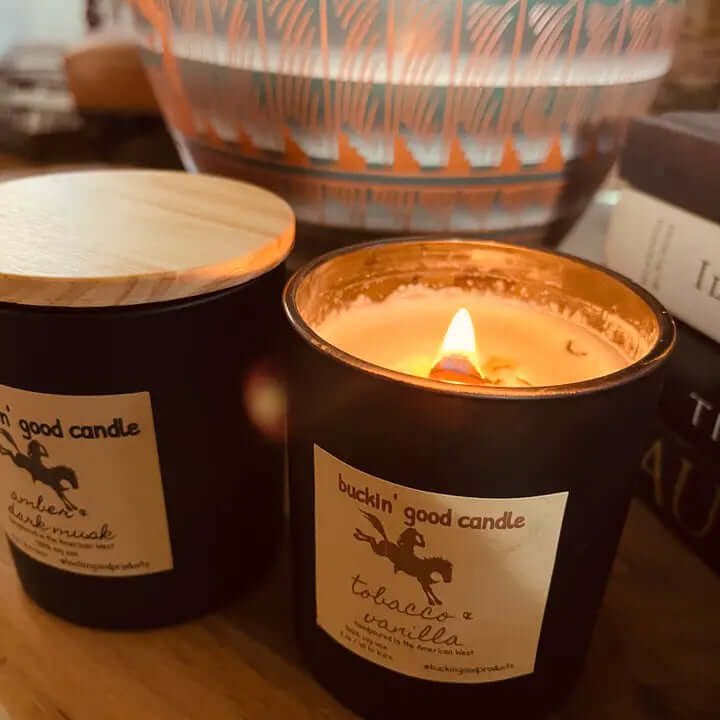 Close-up of Buckin' Good Candle with tobacco & vanilla scent, showcasing the warm glow of the candlelight.