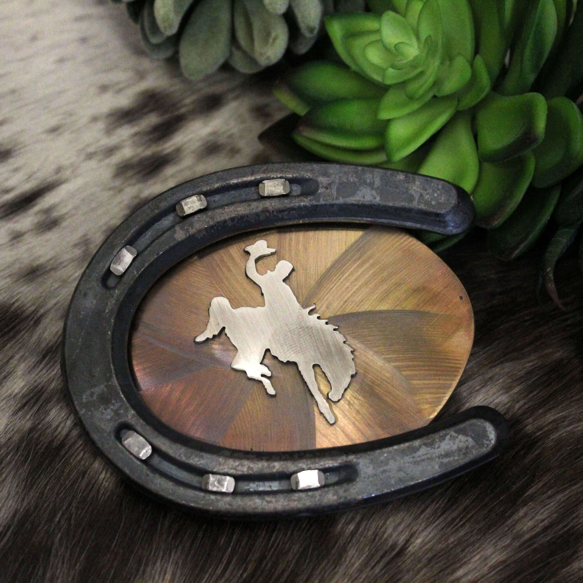 Bucking Horse Pony Horseshoe Cowboy Belt Buckle is a stunning piece crafted from durable stainless steel. This unique buckle features a striking silhouette of a pony boarding a cowboy bronc, encapsulating the spirit of the rodeo. Measuring approximately 4 x 3-1/4 inches, it’s the perfect accessory for any cowboy or cowgirl looking to showcase their love for western culture. Proudly made in the USA