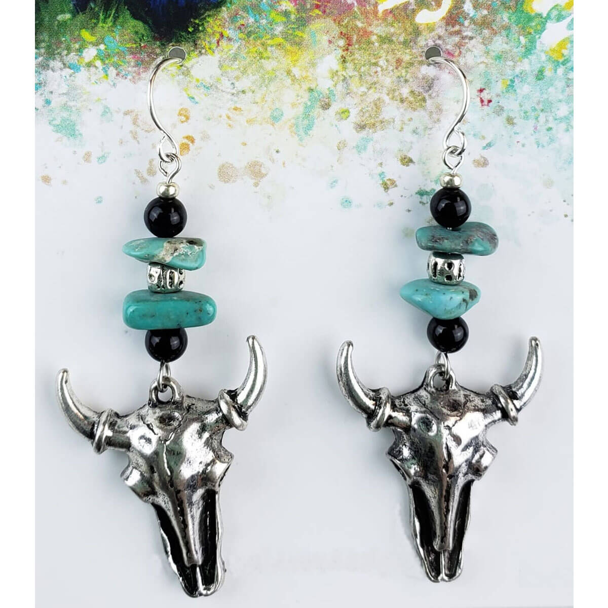 A western twist. The hypoallergenic ear wire holds black onyx beads adorned with Magnesite Turquoise, finished with a Buffalo skull. Handcrafted in the USA. Measures 1.75″ from bottom of ear wire to bottom of earring.