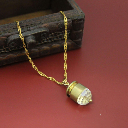 The Bullet Case Gold Necklace features a real S&W 40 bullet encased in luminous crystal and suspended from a 16-18 inch gold chain.