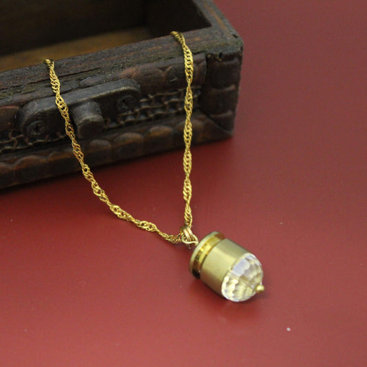 The Bullet Case Gold Necklace features a real S&amp;W 40 bullet encased in luminous crystal and suspended from a 16-18 inch gold chain.