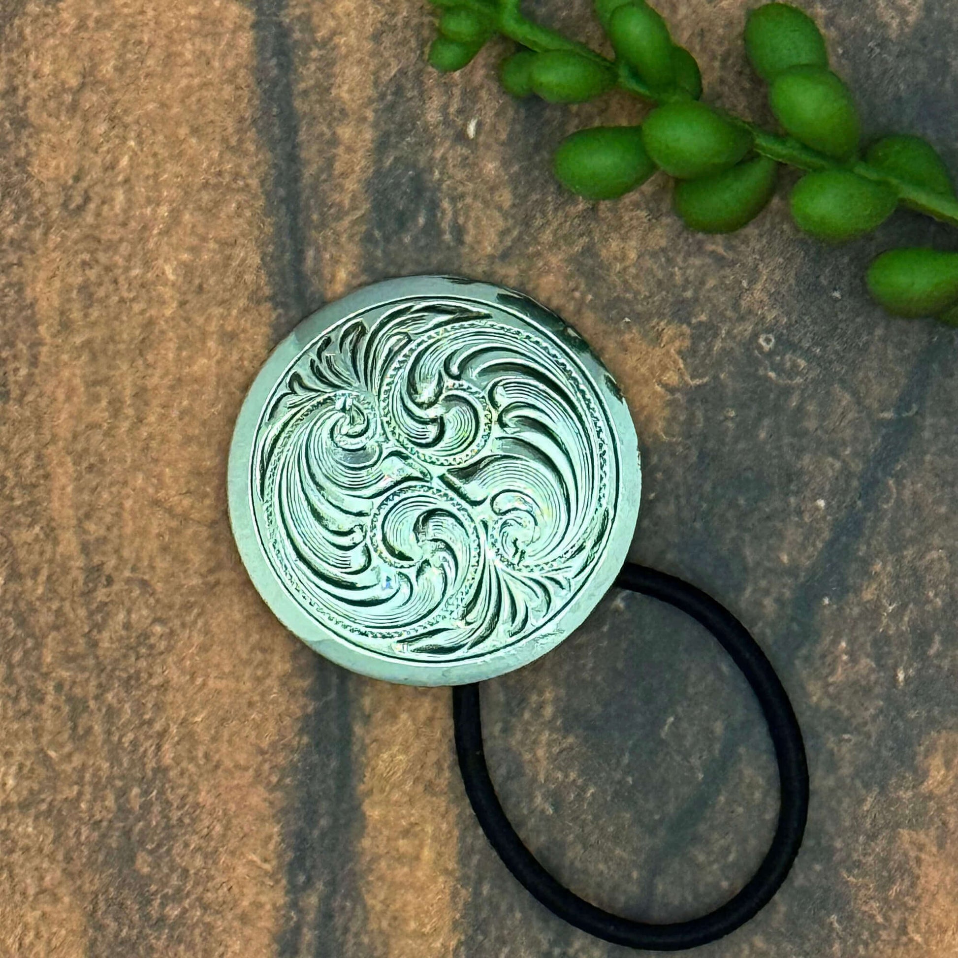 Vintage German silver-plated Concho ponytail holder with elastic band, intricate swirl design, 1 inch diameter, stylish hair accessory.