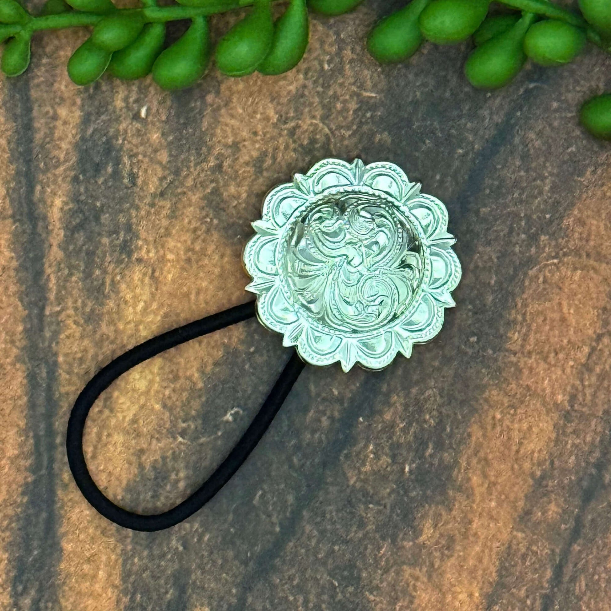 Vintage German silver-plated cowgirl concho ponytail holder on elastic band, ideal for stylish hair accessories.