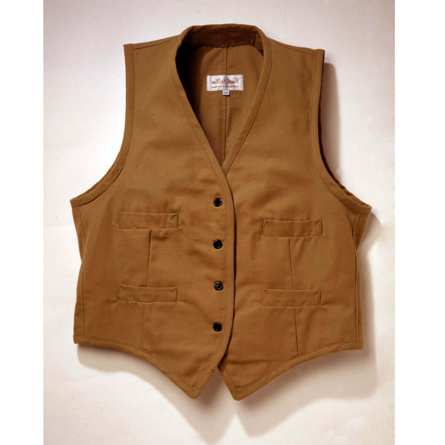 Our sturdy canvas Duck Vest is perfect for fence mending, day riding or just looking good. Made of 100% canvas duck, it comes unlined with four welt pockets. Wear this vest with one of our wild rags for the perfect trail riding outfit. Adjustable back vest buckle Dry clean only. Made in USA.