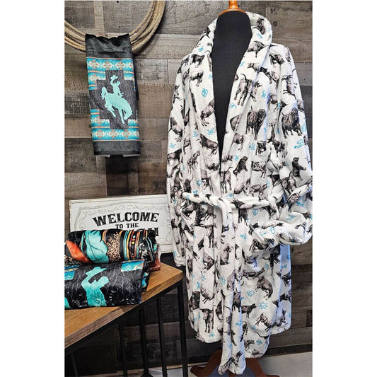 Cozy robe with cow pattern on a mannequin against a wooden wall background.