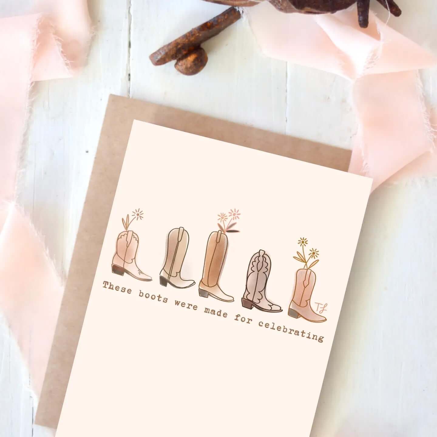 Illustration of colorful cowboy boots on a greeting card with the text "These boots were made for celebrating".