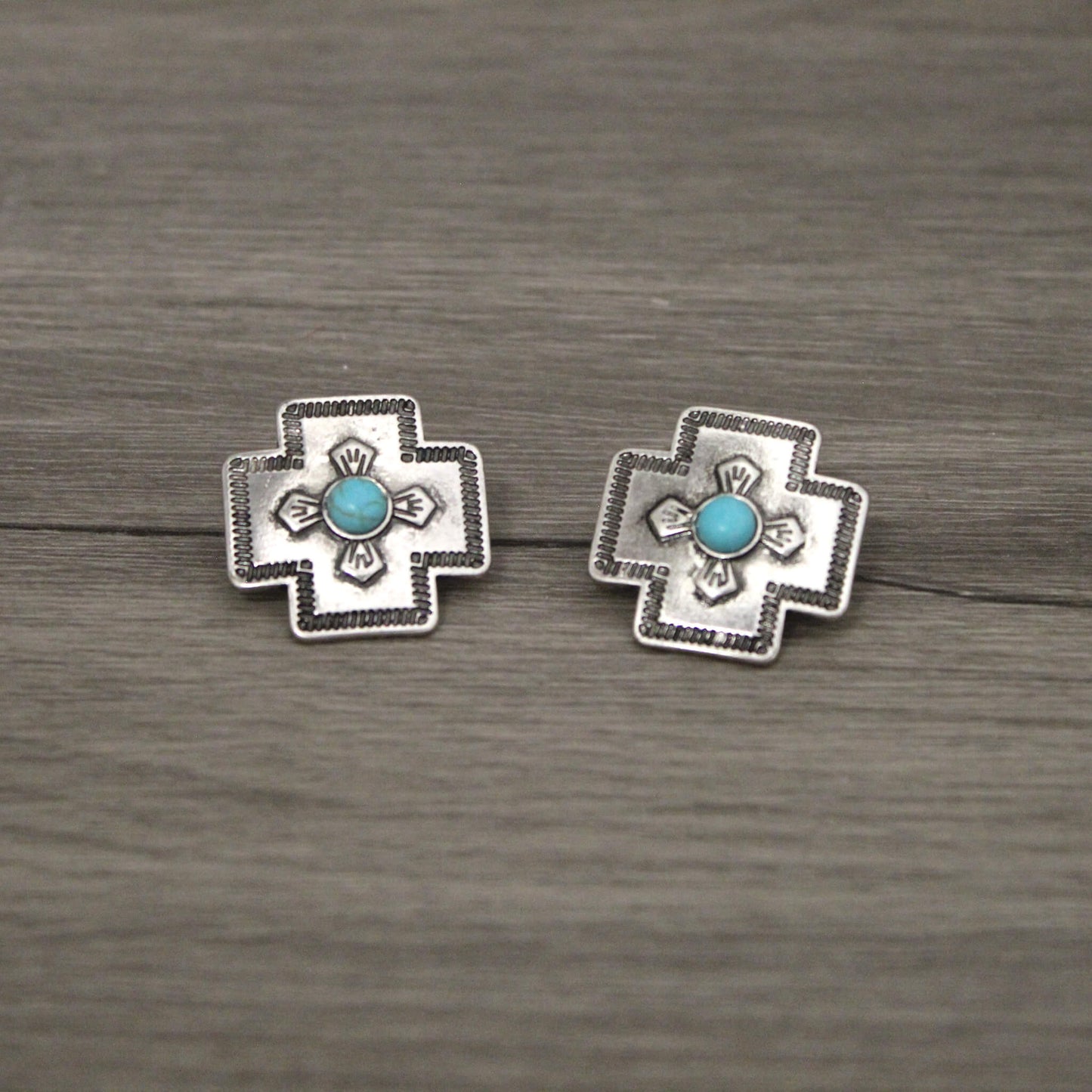 Cute cowgirl chic earrings in go compliment any outfit and appeal to western women of many ages with it's simple and classic antique western look with a touch of turquoise. Stud earrings measures about 1" by 1". Imported