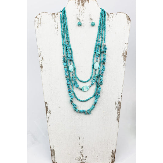 For turquoise and ocean lovers alike. Four layered strands of mag turquoise beads and stone. Longest strand measures 22″ with lobster claw clasp and extension chain. Matched with hypoallergenic ear wires holding a mag turquoise bead.