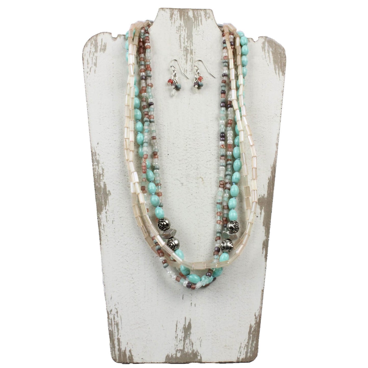 Five Strands of multi-colored beads are the focal points of this eclectic set. Rose shaped accent beads enhance its versatility. Overall length of necklace is 23″ with a lobster claw clasp and extension chain. Matching earrings on hypoallergenic ear wires finish off the look