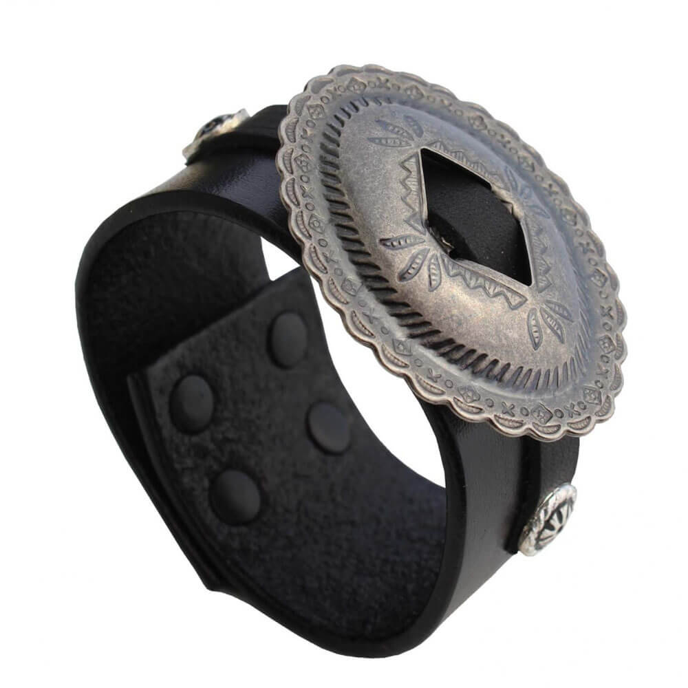 This Cuff Bracelet is made from thick black cowhide leather with a beautiful antique nickel Concho placed in the middle. The bracelet snaps closed and is 1-½” wide. Made in the US