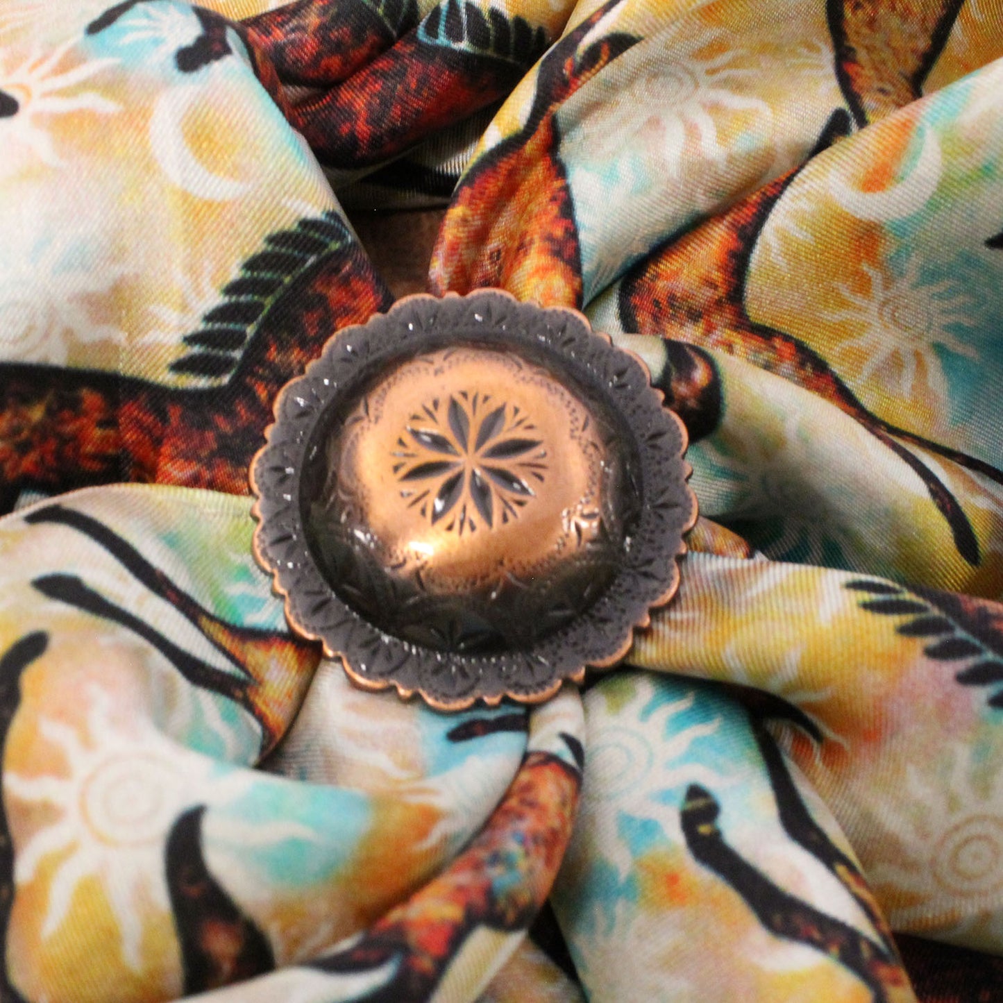 Decorative copper lantern on a colorful fabric background