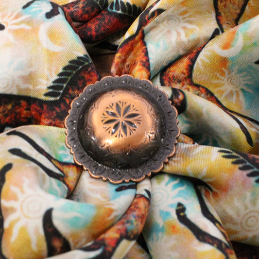 Decorative copper lantern on a colorful fabric background